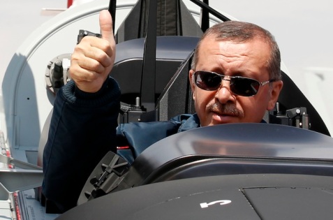 Turkish Prime Minister Tayyip Erdogan gives a thumbs-up sign from the cockpit of the Turkish Primary and Basic Trainer Aircraft "Hurkus" during a ceremony at the Turkish Aerospace Industries in Ankara